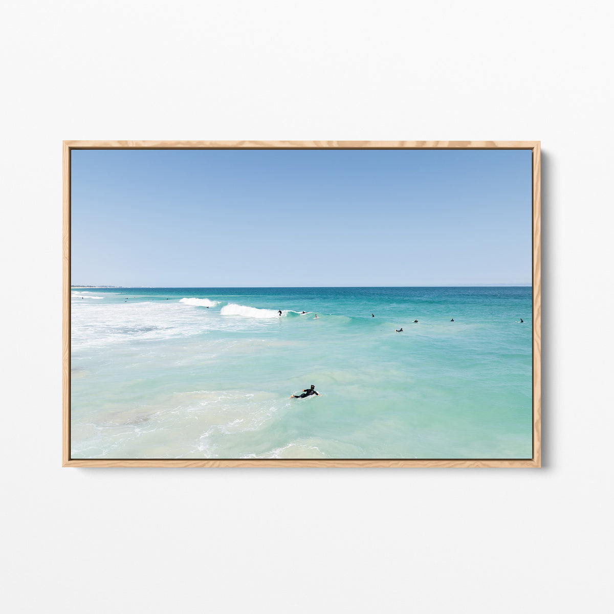 Oak framed canvas print of aerial photography of Scarborough Beach, a surfer lying on a board in clear turquoise shallows