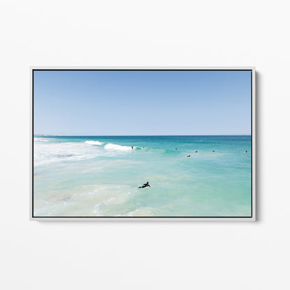 White framed canvas print of aerial photography of Scarborough Beach, a surfer lying on a board in clear turquoise shallows