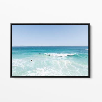 Black framed canvas print of aerial photography of Scarborough Beach, surfers waiting beside a small breaking wave in turquoise water