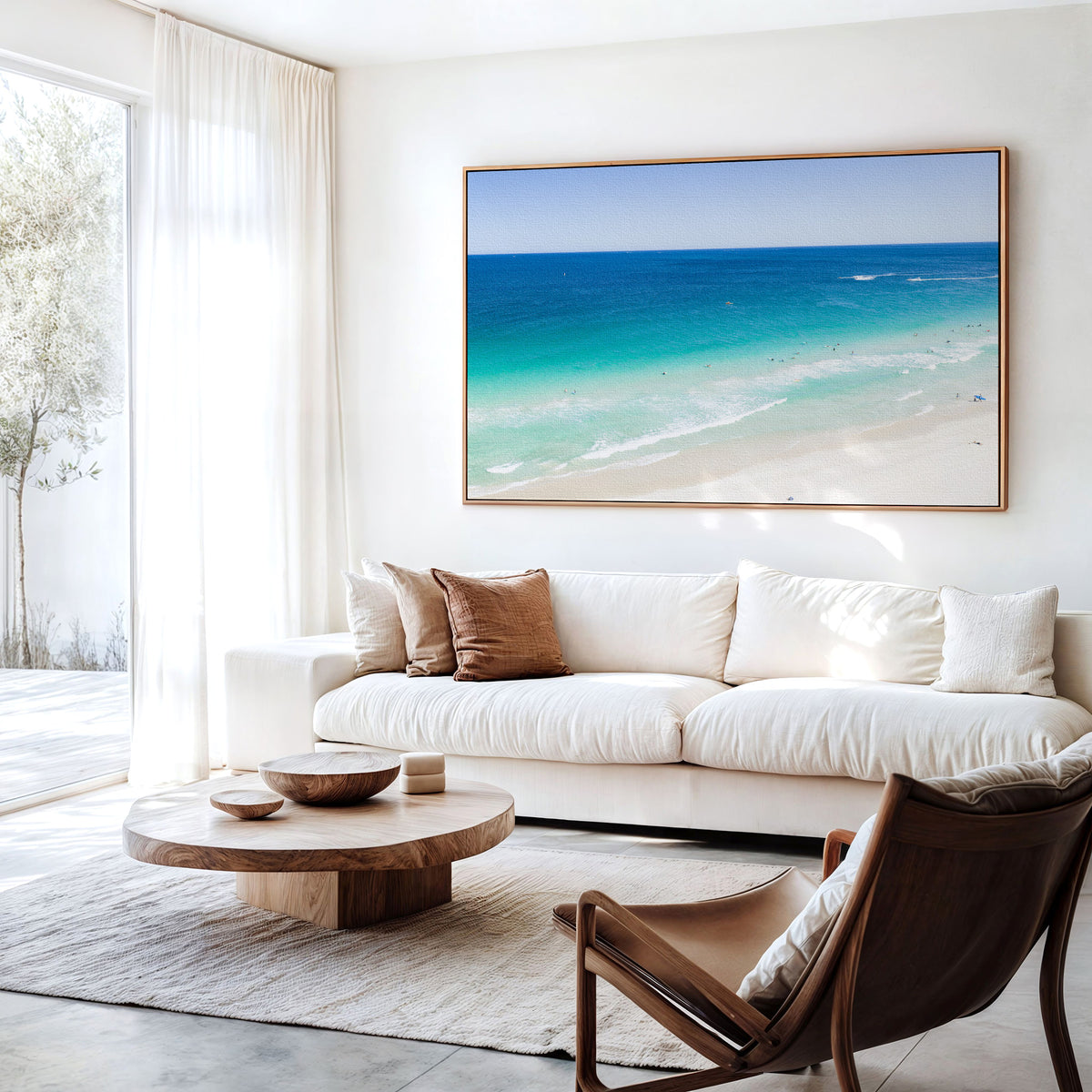 Canvas print of aerial photography of Scarborough Beach, deep blue water, turquoise shallows and pale sand along a diagonal shore hanging above a sofa in a living room