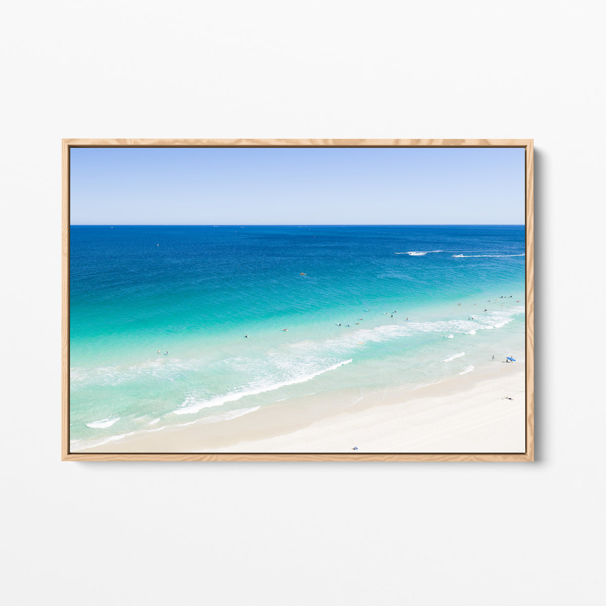 Oak framed canvas print of aerial photography of Scarborough Beach, deep blue water, turquoise shallows and pale sand along a diagonal shore