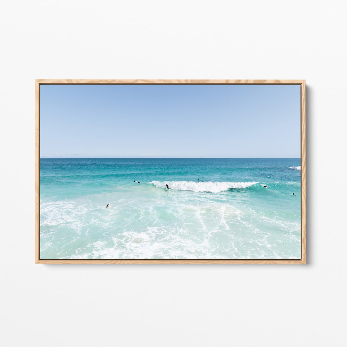 Oak framed canvas print of aerial photography of Scarborough Beach, surfers waiting beside a small breaking wave in turquoise water