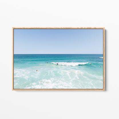 Oak framed canvas print of aerial photography of Scarborough Beach, surfers waiting beside a small breaking wave in turquoise water