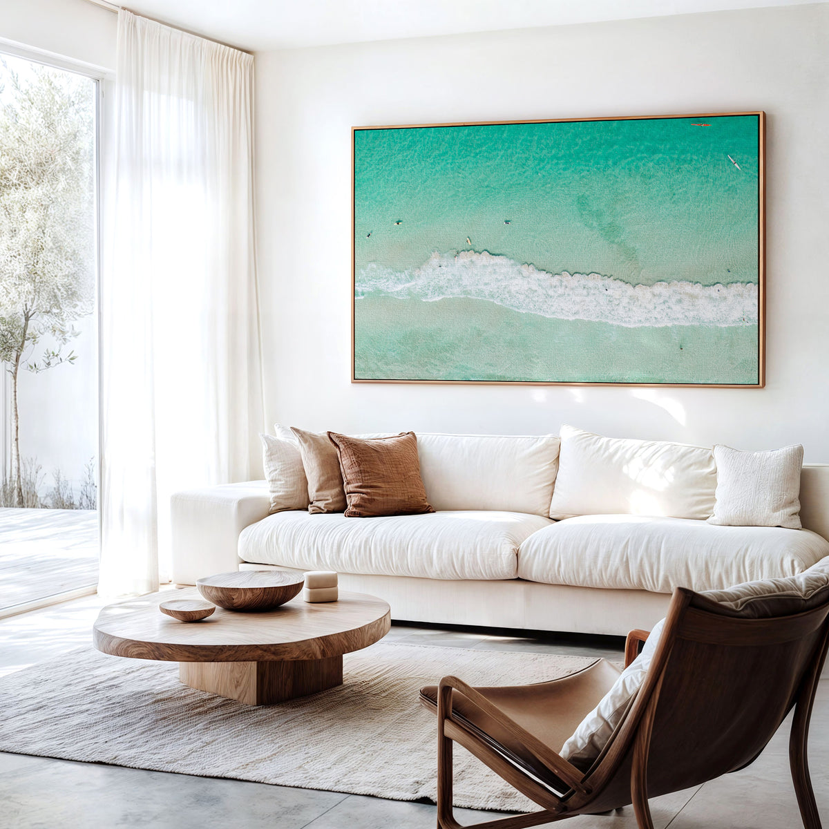 Canvas print of aerial photography of Scarborough Beach, a line of white wave across green turquoise shallows with shadows on the sea floor hanging above a sofa in a living room
