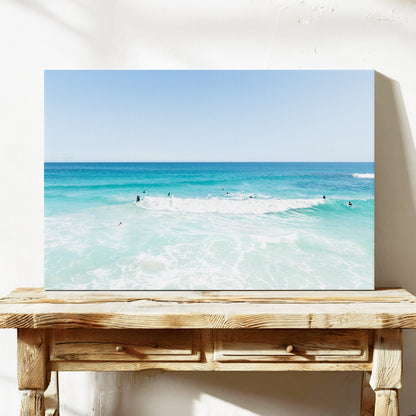Stretched canvas print of aerial photography of Scarborough Beach, a wide view of surfers spread across turquoise water and white foam on a console table