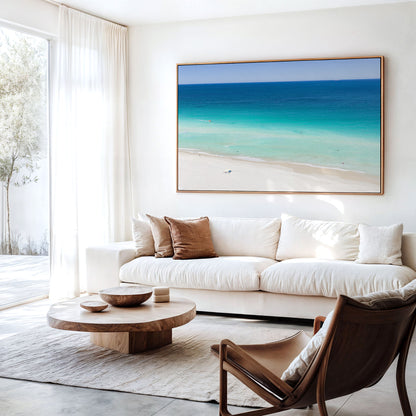 Canvas print of aerial photography of Scarborough Beach, deep blue water, turquoise shallows and an almost empty white sand beach hanging above a sofa in a living room