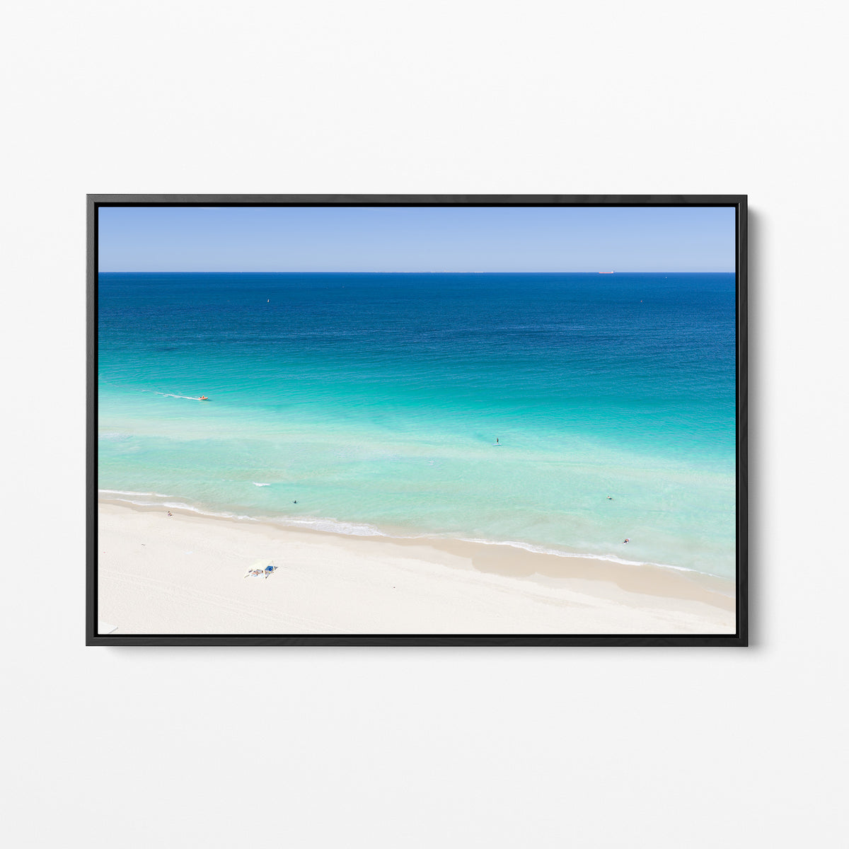 Black framed canvas print of aerial photography of Scarborough Beach, deep blue water, turquoise shallows and an almost empty white sand beach