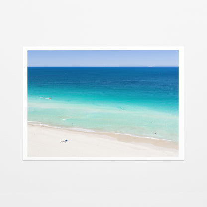 Fine art paper print of aerial photography of Scarborough Beach, deep blue water, turquoise shallows and an almost empty white sand beach with a white border