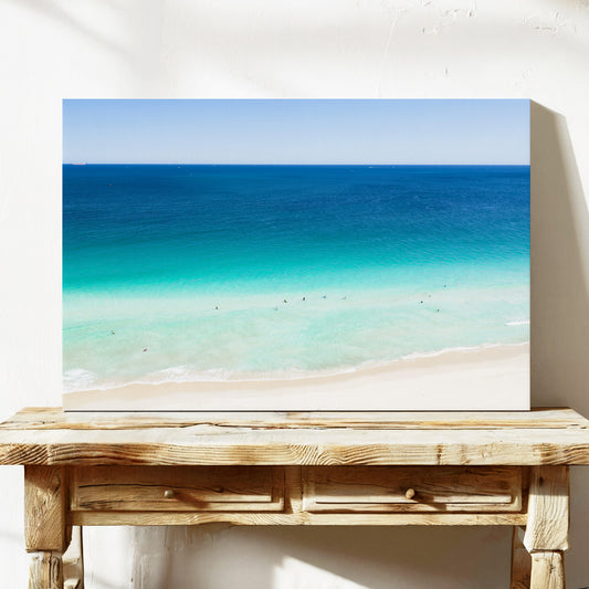 Stretched canvas print of aerial photography of Scarborough Beach, dark blue ocean, a turquoise band of shallows and pale sand on a console table