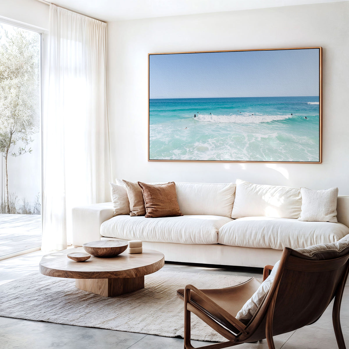 Canvas print of aerial photography of Scarborough Beach, a wide view of surfers spread across turquoise water and white foam hanging above a sofa in a living room