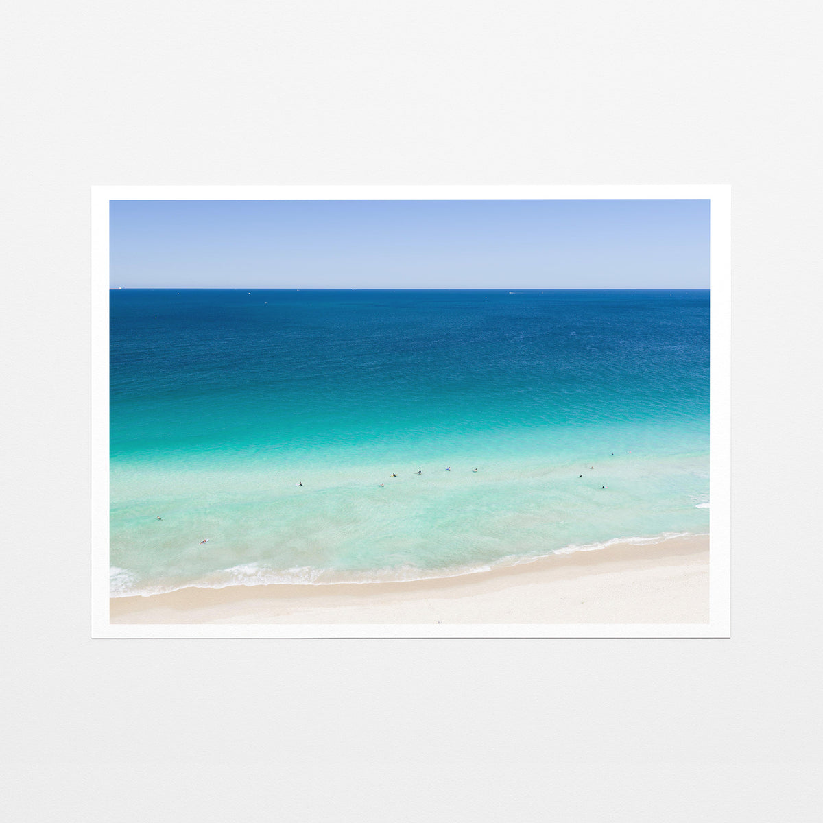 Fine art paper print of aerial photography of Scarborough Beach, dark blue ocean, a turquoise band of shallows and pale sand with a white border