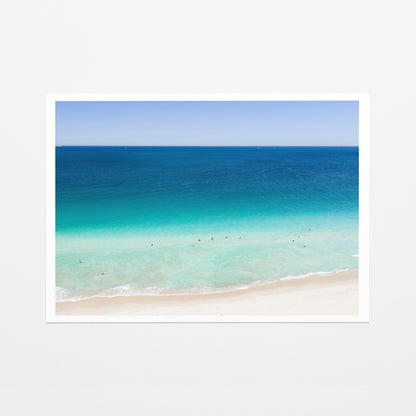 Fine art paper print of aerial photography of Scarborough Beach, dark blue ocean, a turquoise band of shallows and pale sand with a white border