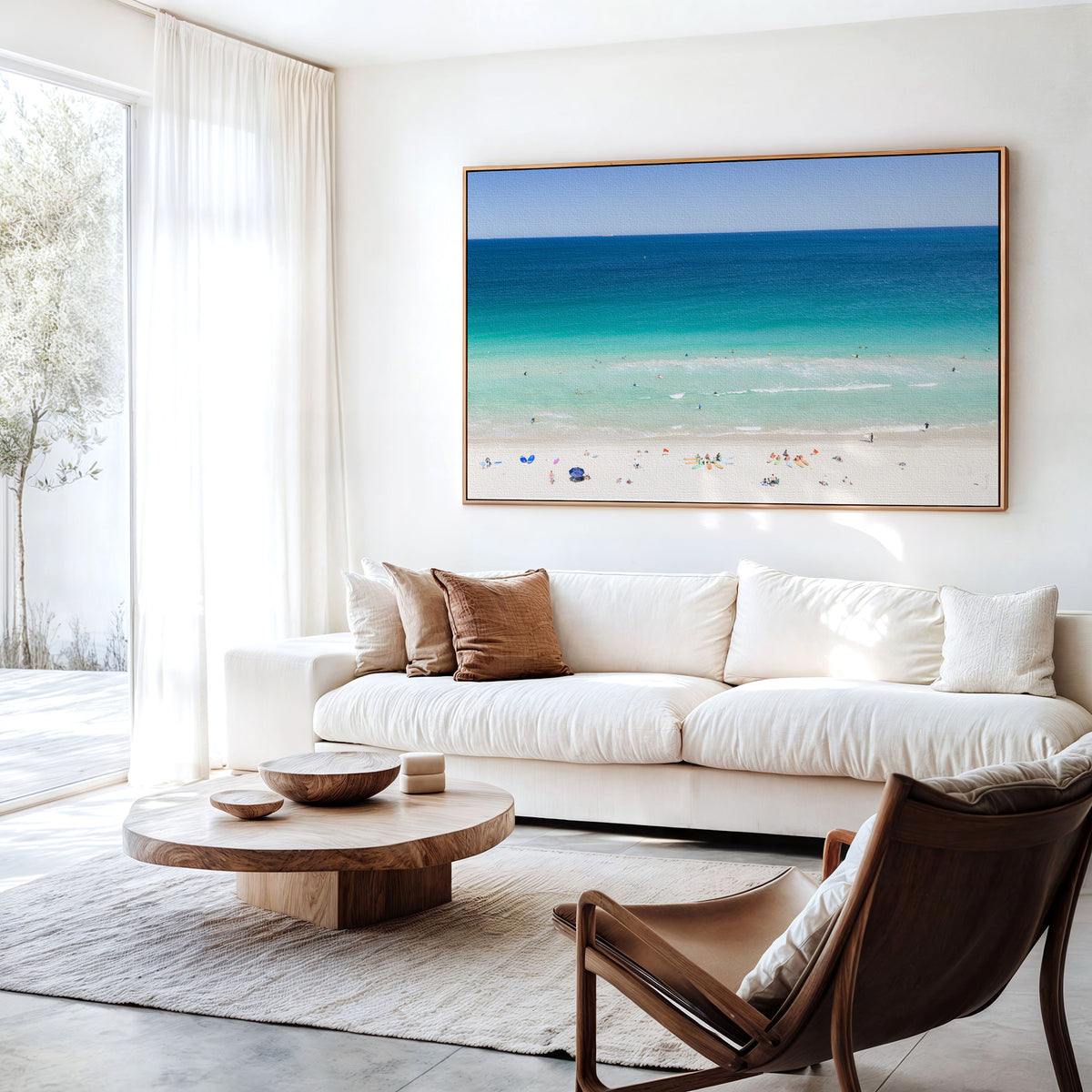 Canvas print of aerial photography of Scarborough Beach, colourful umbrellas and people on white sand beside turquoise water and deep blue ocean hanging above a sofa in a living room