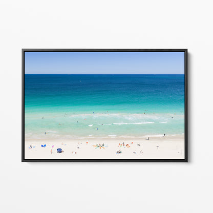 Black framed canvas print of aerial photography of Scarborough Beach, colourful umbrellas and people on white sand beside turquoise water and deep blue ocean