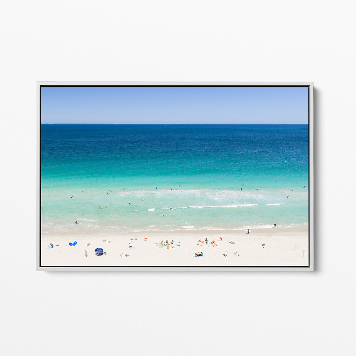 White framed canvas print of aerial photography of Scarborough Beach, colourful umbrellas and people on white sand beside turquoise water and deep blue ocean