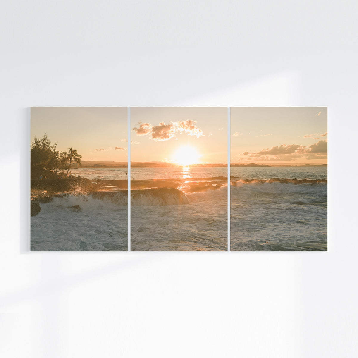 Snapper Rocks sunset three piece canvas wall art on wall