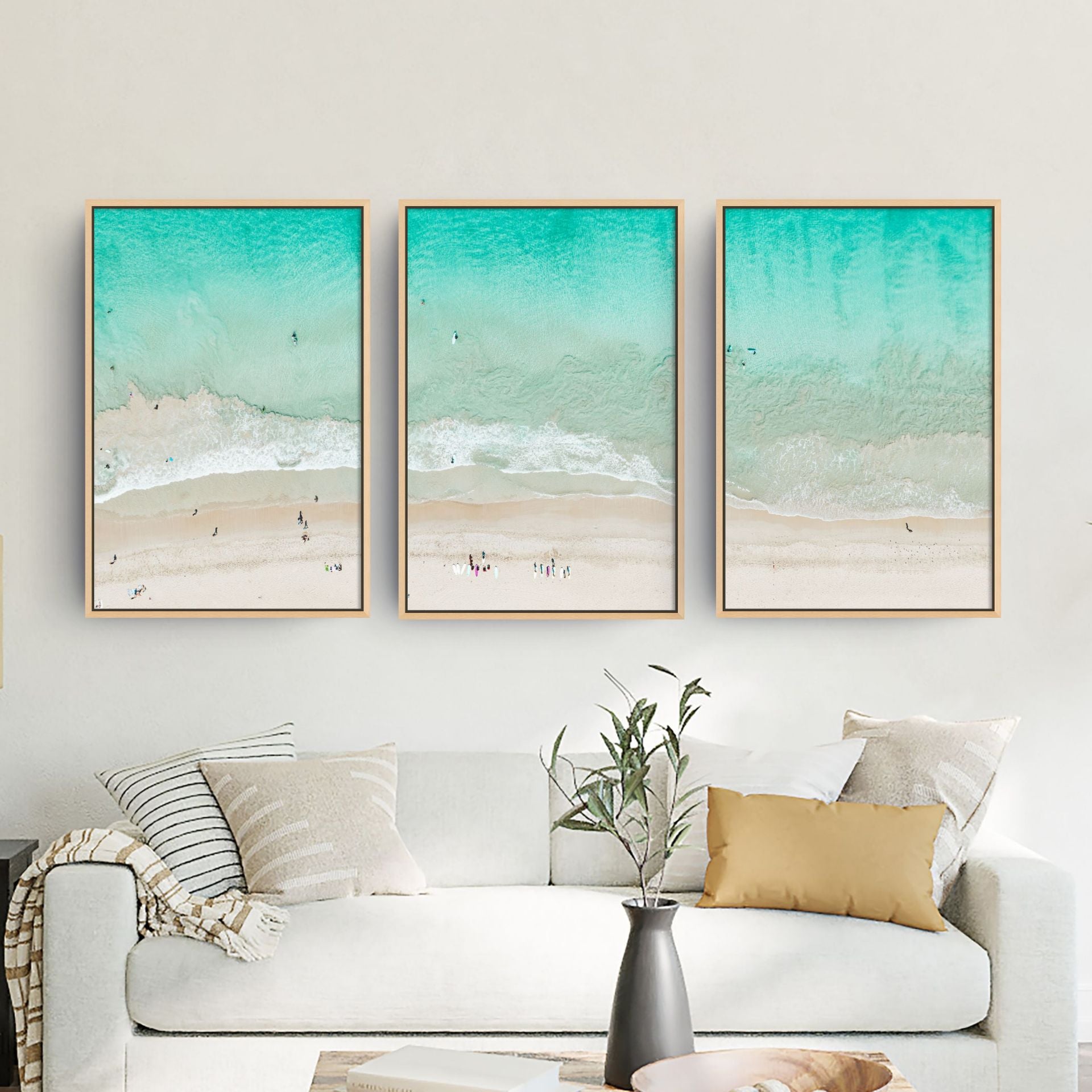 Three-piece framed canvas of ocean photography displayed in a living room