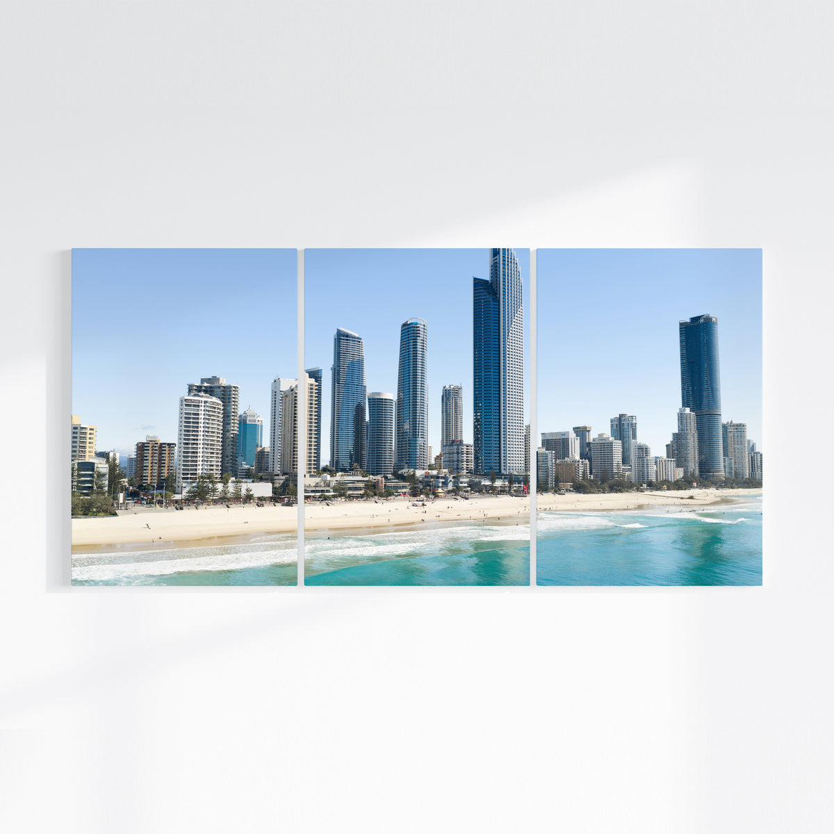 Surfers Paradise three piece canvas wall art on wall